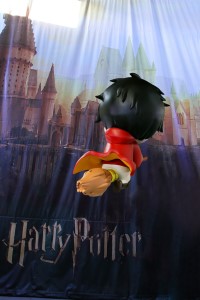 Harry Potter flying over Hogwarts on his way to quidditch practice