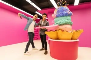 Posing for a selfie with a giant cup of ice cream with sprinkles