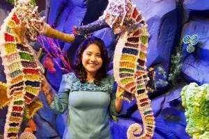 Woman taking selfie with Seahorses at Candytopia